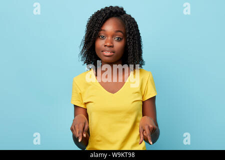 good looking student showing something which is lying on the floor. close up photo Stock Photo