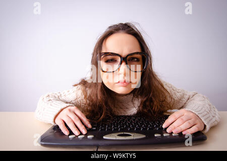 The funny nerd girl working on computer Stock Photo