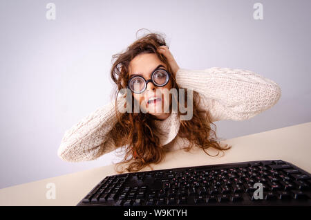 The funny nerd girl working on computer Stock Photo