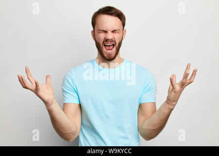 angry nervous man isn't satisfied with his work. close up portrait. isolated white background. studio shot Stock Photo