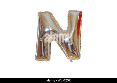 N made of silver balloons isolated on white background. English N from silver balloons isolated on white background .Letter N made of chrome silver in Stock Photo