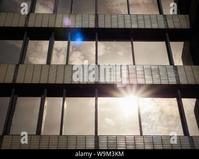 Sunlight reflecting off brown/bronze 1970s-built office complex windows in straight rows with a diminishing perspective. Fountain Precinct, Sheffield Stock Photo