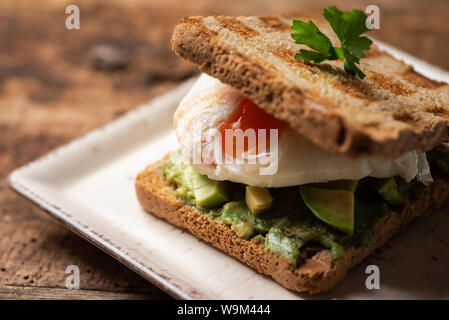 Fresh toast sandwich with fried egg and avocado Stock Photo