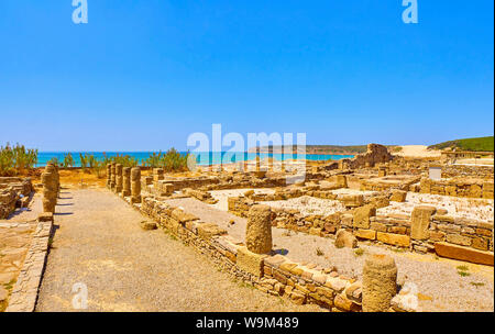 Street of the Columns of Baelo Claudia Archaeological Site, with the Bolonia Beach in the background. Tarifa, Cadiz. Andalusia, Spain. Stock Photo