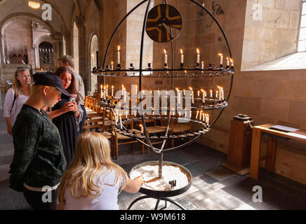 Family lighting candle in church; Lund cathedral interior, Lund, Sweden, Scandinavia Europe Stock Photo