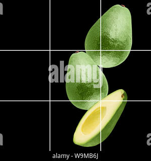 Falling avocado fruit isolated on black background Stock Photo
