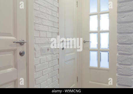 White classic doors and white decorative brick wall. Stock Photo