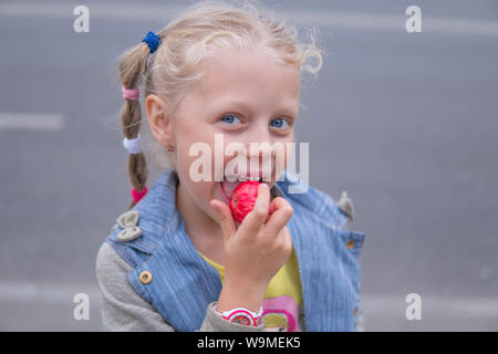 Portrait of beautiful little girl with apple Isolated on white, funy Stock Photo