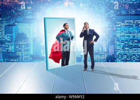 The businessman seeing himself in mirror as superhero Stock Photo
