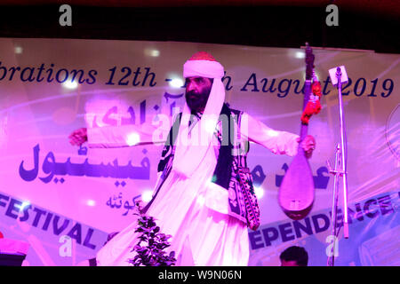 QUETTA, PAKISTAN, Aug 14-2019: famous Balochi and brahvi language singer Akhtar Channal Zehri performing Balochi song during musical event regarding t Stock Photo