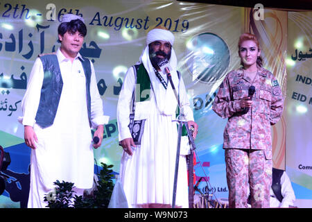 QUETTA, PAKISTAN, Aug 14-2019: famous Pakistani singer Akhtar Channal Zehri performing song with Drama Artist Abdullah Achakzai and Film star Pakiza k Stock Photo
