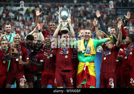 Liverpool's Jordan Henderson lifts the trophy after the final whistle during the UEFA Super Cup Final at Besiktas Park, Istanbul. Stock Photo