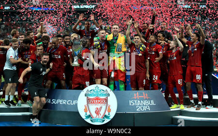 Liverpool's Sadio Mane (centre left), Jordan Henderson (centre) and goalkeeper Adrian (centre right) celebrate with the trophy alongside team-mates after the UEFA Super Cup Final at Besiktas Park, Istanbul. Stock Photo