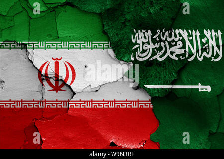 flags of Iran and Saudi Arabia painted on cracked wall Stock Photo