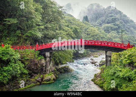 A rain storm at the Shinkyo, or Sacred Bridge, crossing the Daiya River in Nikko, Japan.  The first bridge was built in 808 and has been rebuilt many Stock Photo