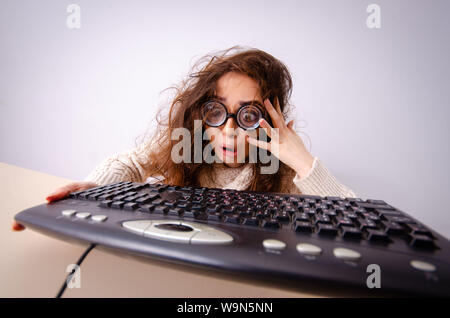 The funny nerd girl working on computer Stock Photo
