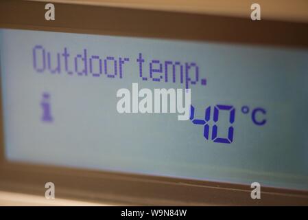 Temperature display: close up of a central heating boiler liquid crystal display panel showing an exterior temperature of 40˚Celsius Stock Photo