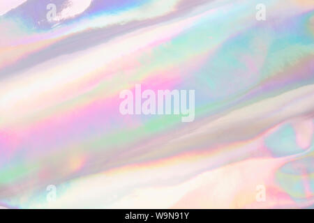 Holographic iridescent color wrinkled fabric. Abstract texture with multiple colors. Stock Photo