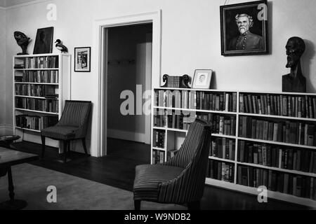 The Library with a portrait of the homeowner's ancestor, Pulitzer Prize winning author, William Faulkner, inside his residence, Rowan Oak, Oxford, MS Stock Photo