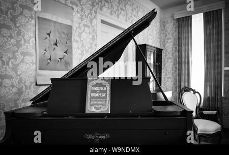 A baby grand style piano awaits an audience in the parlor at 'Rowan Oak', once the residence of pultizer prize winner, author William Faulkner, in Oxf Stock Photo