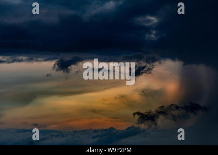 Beautiful sunset sky. Orange, blue, and white sky. Colorful sunrise. Art picture of sky at sunrise. Sunrise and clouds for inspiration background. Stock Photo