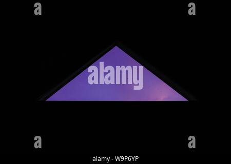 Cool background with a purple triangle on a dark background Stock Photo