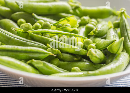 Fresh green pea seeds and pods - Close up Stock Photo