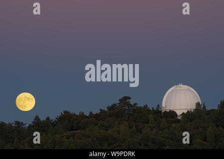 Full moon rising at Mt Wilson Observatory in California. Mt Wilson is located on San Gabriel Mountains. Stock Photo