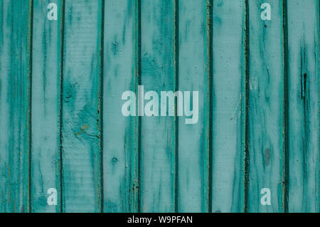 Old weathered grunge green painted wooden boards wall closeup as background Stock Photo