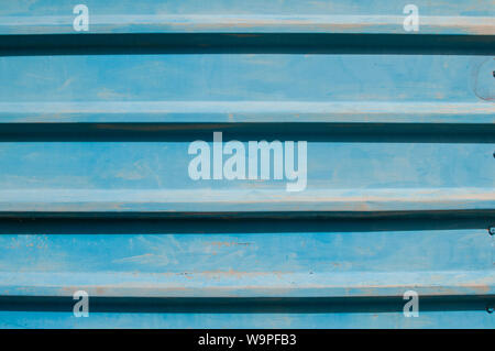 Weathered blue painted tin corrugated steel sheet closeup as metal background Stock Photo