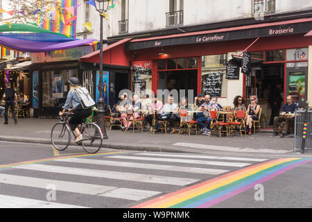 Paris street scene - scene on Rue des Archives, permanently coloured in rainbow symbols in the Marais district, Paris, France, Europe. Stock Photo