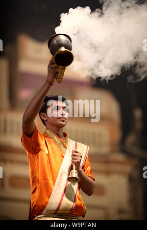 Hindu priest performs an aarti at Dashashwamedh Ghat in Varanasi. Varanasi is the holiest of the seven sacred cities in India Stock Photo