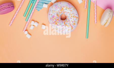 Donut, macaroons and marshmallows on pastel background. Party concept, banner Stock Photo
