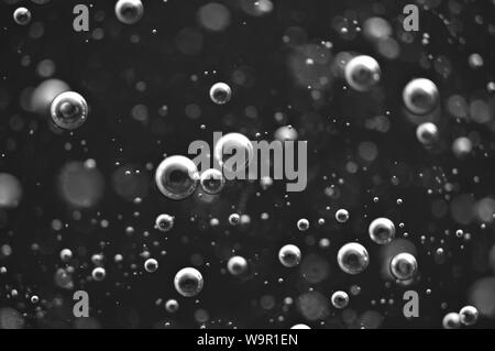 Bubbles of oxygen or air in a dark liquid. For projects with liquid or oil. Macro Stock Photo