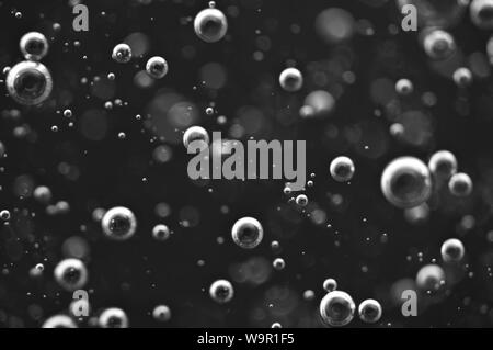 Bubbles of oxygen or air in a dark liquid. For projects with liquid or oil. Macro Stock Photo