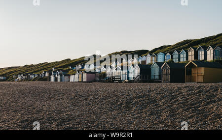 Panoramic view of beach huts during sunset in Milford on Sea, Hampshire, UK.