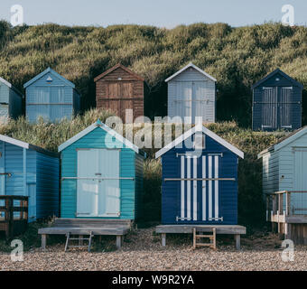 Two rows of colorful beach huts in Milford on Sea, New Forest, UK. Stock Photo