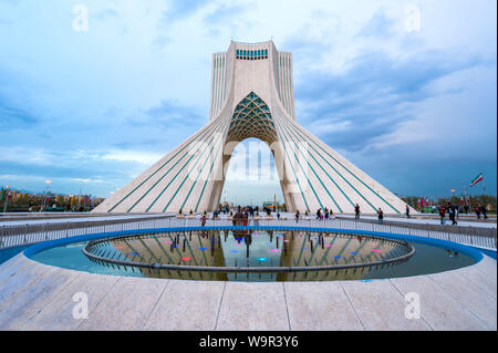 Azadi Tower or Borj-e Azadi tower or Freedom Monument formerly known as Shahyad Tower and cultural complex reflecting in a pond, Tehran, Islamic Repub Stock Photo