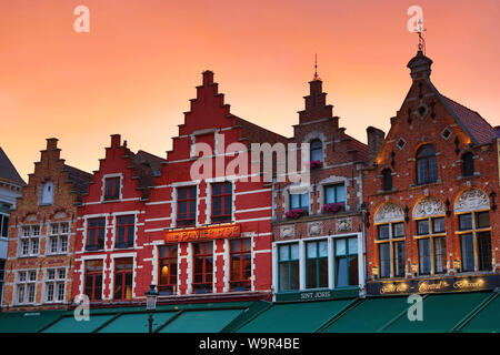 Guild houses converted into restaurants at sunset in the Market Square or Markt, Bruges, Belgium Stock Photo
