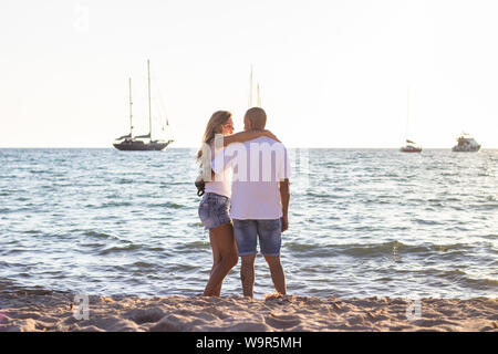 Young happy couple on vacation having fun  walking on sea beach Stock Photo