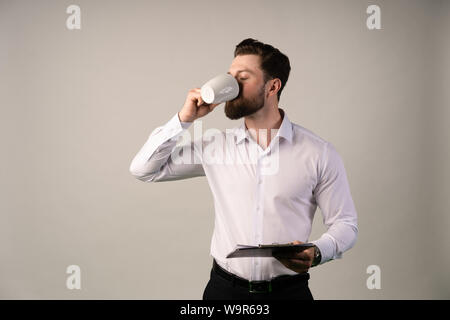 Confident successful businessman in suit enjoying a cup of coffee while having work break lunch in modern restaurant,young intelligent man or entrepre Stock Photo
