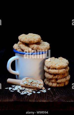 Oatmeal cookies in cup, oat flakes Stock Photo