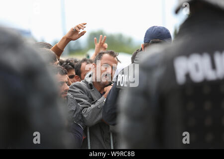 Bregana, Slovenia - September 20, 2015 : The police choosing syrian refugees from the crowd to take them to the bus one by one on the slovenian border Stock Photo