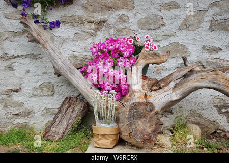 Stone house decorated with branch and flowers Stock Photo