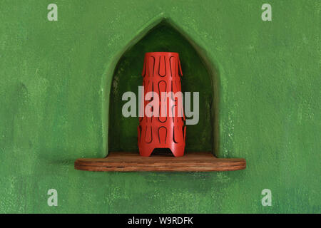 Red lamp on a wooden shelf encased in a green wall of a typical rural house in Fuerteventura, Spain. Interior close up view of a design object. Colorf Stock Photo