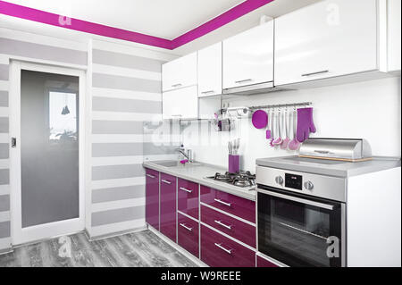 kitchen interior in purple, white and gray colours. Trendy ultraviolet kitchen room design. Modern home interior