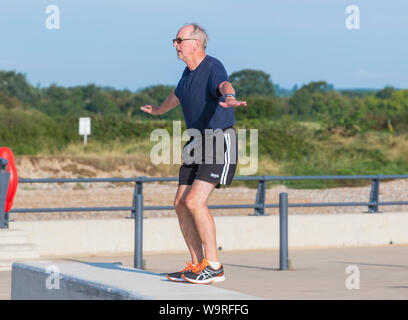 Middle aged man doing yoga exercises in the morning in the UK. Stock Photo