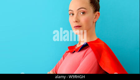 Self-confident woman in red cape, super hero Stock Photo