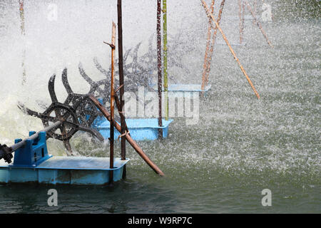 Oxygen generator is hitting the surface to create the bubbles for wastewater treatment. Stock Photo