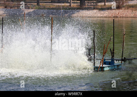 Oxygen generator is hitting the surface to create the bubbles for wastewater treatment. Stock Photo